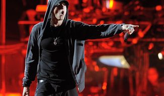 FILE - This April 15, 2012 file photo shows Eminem performing at the 2012 Coachella Valley Music and Arts Festival in Indio, Calif. Eminem and Outkast will headline this year’s Lollapalooza music festival on Aug. 1-3, 2014, in Chicago. Festival founder Perry Farrell announced the lineup of more than 130 acts on Wednesday, March 26, 2014. (AP Photo/Chris Pizzello, File)