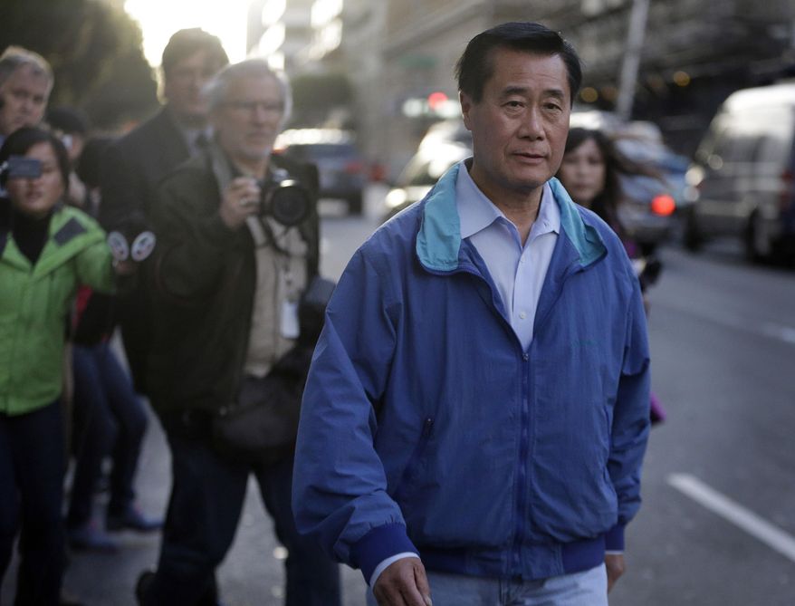California Sen. Leland Yee, D-San Francisco, right, leaves the San Francisco Federal Building, Wednesday, March 26, 2014, in San Francisco. The FBI has filed a 137-page affidavit outlining a detailed corruption case against Yee, who is accused of asking for campaign donations in exchange for introducing an undercover agent to an arms trafficker. (AP Photo/Ben Margot)