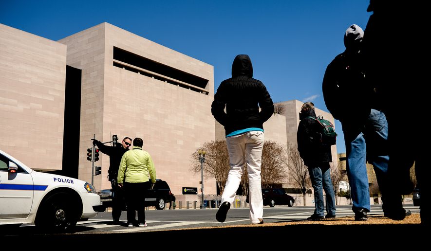 The Smithsonian&#39;s Air and Space Museum on the National Mall is evacuated after a report of a suspicious package, Washington, D.C., Wednesday, March 26, 2014. (Andrew Harnik/The Washington Times)