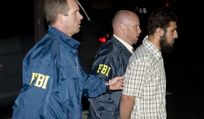 Terrorism suspect Najibullah Zazi is arrested by FBI agents in Aurora, Colo., on Saturday, Sept. 19, 2009. (AP Photo/Chris Schneider - Denver Post) - MANDATORY CREDIT -