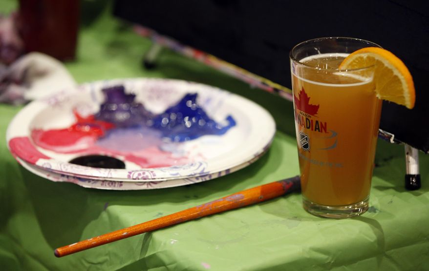 In this Tuesday, March 25, 2014 photo, a participant's supplies are shown during a Paint Nite event at the Field House sports bar in Philadelphia. Cities like Philadelphia, Boston and New York are offering a creative way to socialize and bring out your inner artist: Paint Nite. A ticket buys you a small canvas, brushes, paints and an easy two-hour lesson at a neighborhood bar. (AP Photo/Matt Slocum)