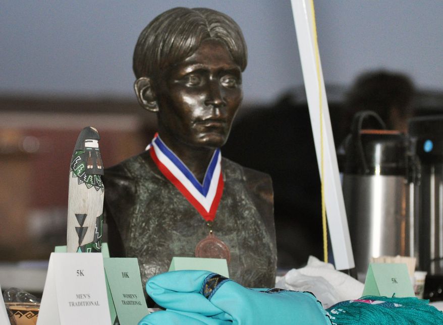 This 2010 photo provided by Matthew Sakiestewa Gilbert shows a bronze bust of famed Hopi runner Louis Tewanima on display at an annual footrace that honors him on the Hopi reservation in northeastern Arizona. A criminal complaint filed in Hopi tribal court alleges that former tribal Chairman Ben Nuvamsa stole the bust from a museum on the reservation in August 2013, which he disputes. (AP Photo/Matthew Sakiestewa Gilbert)