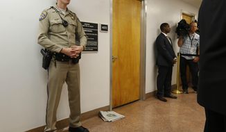 A California highway patrol officer stands outside the office of Sen. Leland Yee, D-San Francisco, at the state Capitol, Wednesday, March 26, 2014, in Sacramento, Calif. FBI spokesman Peter Lee said Yee was arrested Wednesday, he declined to discuss the charges, citing an ongoing investigation. (AP Photo/Rich Pedroncelli)