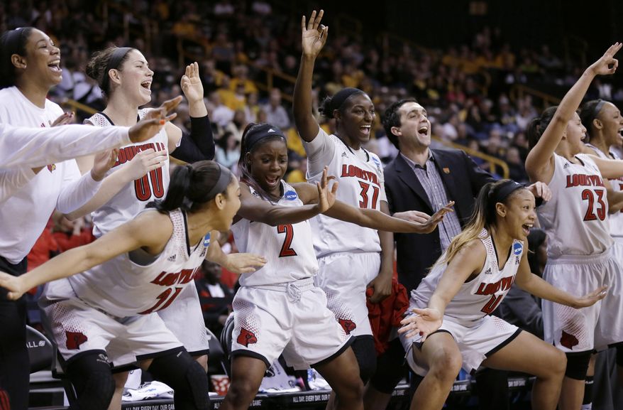 Louisville players celebrate at the end of an NCAA women's college basketball tournament second-round game against Iowa, Tuesday, March 25, 2014, in Iowa City, Iowa. Louisville won 83-53. (AP Photo/Charlie Neibergall)