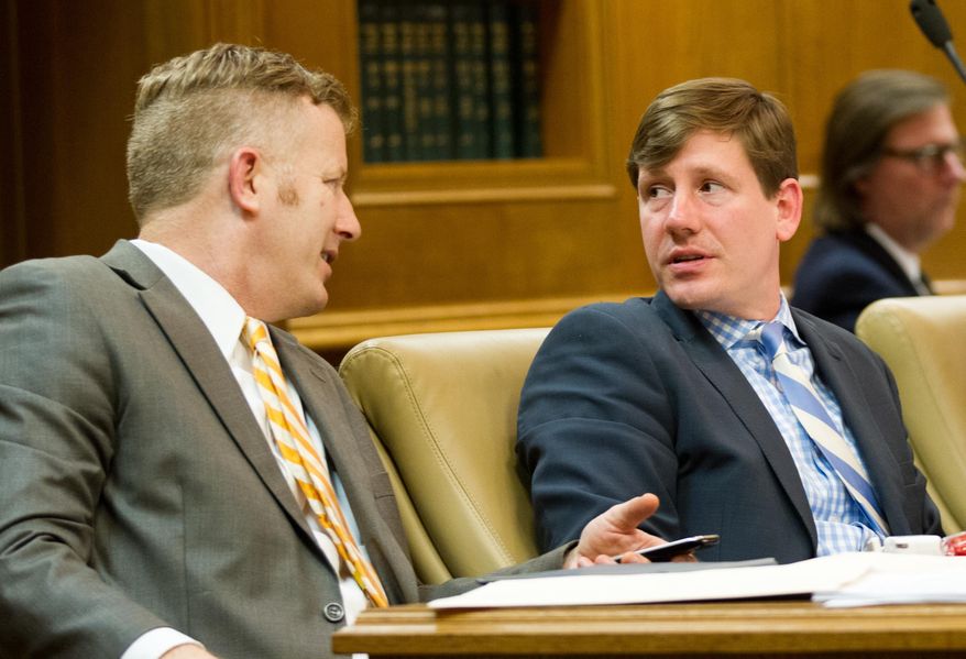 Republican Sens. Brian Kelsey of Gemrantown, right, and Stacey Campfield of Knoxville confer during a meeting of the Senate Education Committee in Nashville, Tenn., on Wednesday, March 26, 2014. The panel later advanced Gov. Bill Haslam's proposal to create a limited school voucher program in Tennessee. (AP Photo/Erik Schelzig)