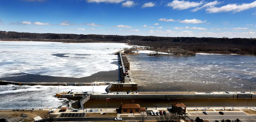 In this March 25, 2014 photo, water passes on the Mississippi River that is still mostly frozen north of Lock and Dam 11 in Dubuque, Iowa. Some Mississippi River shipping ports remain closed with a record amount of ice lingering longer than usual. (AP Photo/The Telegraph Herald, Dave Kettering)
