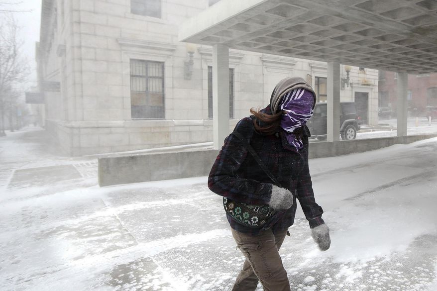 A woman fights through wind-driven snow as she crosses a street during a spring snowstorm in downtown New Bedford, Mass., Wednesday, March 26, 2014. The storm brought high winds that whipped snow across portions of Massachusetts and eastern Maine, causing near-whiteout conditions on Cape Cod and roiling the Atlantic as it moved up the coast. (AP Photo/The Standard-Times, Peter Pereira)
