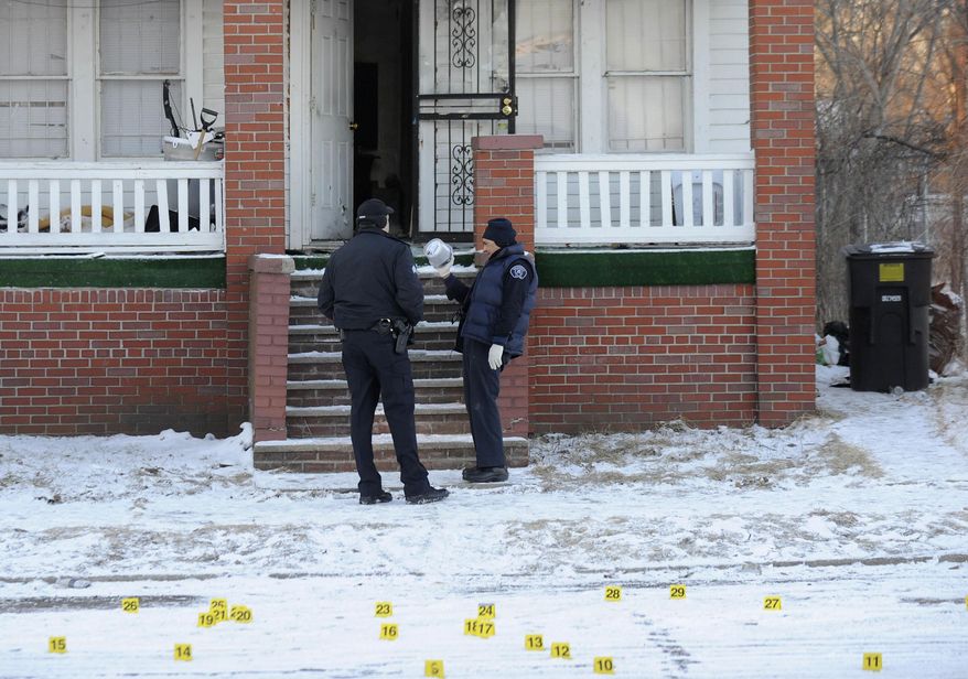 Authorities investigate the scene after a shooting in Detroit, Wednesday, March 26, 2014. Police say the shooting left one man dead and another critically wounded. (AP Photo/Detroit News, David Coates) DETROIT FREE PRESS OUT; HUFFINGTON POST OUT