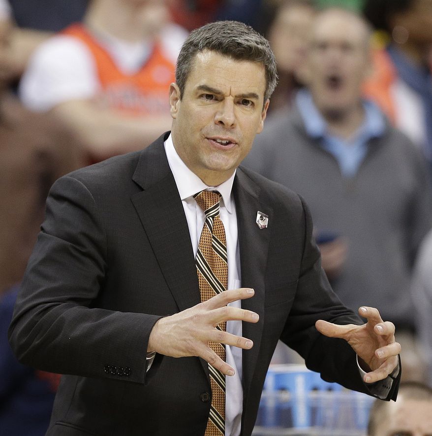 Virginia head coach Tony Bennett speaks to players against Coastal Carolina during the first half of an NCAA college basketball second-round tournament game, Friday, March 21, 2014, in Raleigh. (AP Photo/Chuck Burton)