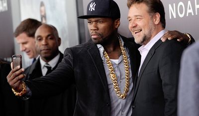 Rapper and actor Curtis &quot;50 Cent&quot; Jackson, left, takes a selfie with actor Russell Crowe at the premiere of &quot;Noah&quot; at the Ziegfeld Theatre on Wednesday, March 26, 2014, in New York. (Photo by Evan Agostini/Invision/AP)