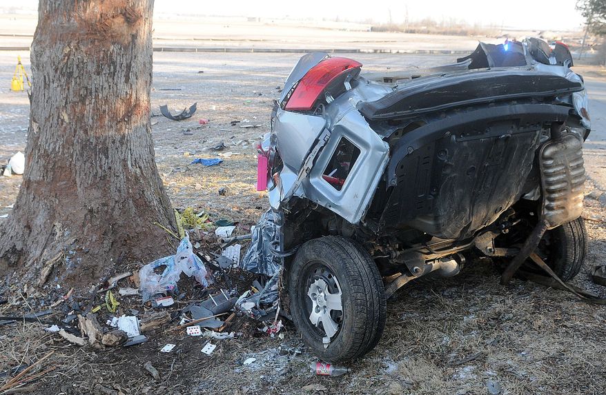 In this photo taken on Wednesday, March 26, 2014, part of the wreckage of a car accident that killed three teenagers rests near a tree in Springfield, Ohio. A news release from the State Highway Patrol says the car went off a road and was split in half by the impact with a tree. The patrol says 17-year-old Daniel Tittle of Medway, 15-year-old Wesley Culpepper of Huber Heights and 16-year-old Charles Luthe of Springfield, were killed in the crash. (AP Photo/The Springfield News-Sun, Marshall Gorby)