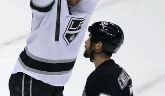 Los Angeles Kings&#39; Jeff Carter (77) celebrates his goal as Pittsburgh Penguins&#39; Deryk Engelland (5) heads back to his bench in the first period of an NHL hockey game in Pittsburgh, Thursday, March 27, 2014. (AP Photo/Gene J. Puskar)