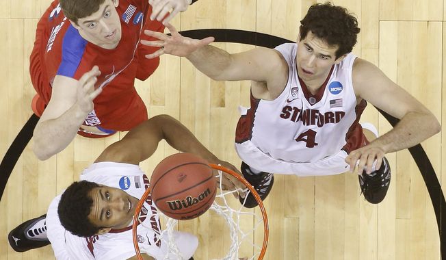 Stanford center Stefan Nastic (4) and Dayton forward/center Matt Kavanaugh (35) vie for a loose ball during the first half in a South regional semifinal game at the NCAA Tournament on Thursday in Memphis, Tenn. (Associated Press)