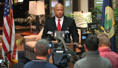 Elkhart County Prosecutor Curtis Hill addresses the media at his office in Elkhart, Ind. Thursday, March 27, 2014. Hill announced the killing of alleged gunman Sean Bair by Elkhart Police officers Jason Tripp and Cody Skipper was justified and that the officers would not face any charges.  Hill says he won&#39;t convene a grand jury to review the actions of Tripp and Skipper. They shot the gunman who was threatening to shoot the store manager when they arrived. Hill also says the coroner was unable to determine whether Shawn Bair died from a shot to the heart by police or a self-induced head wound since they occurred nearly simultaneously. (AP Photo/The Elkhart Truth, Jennifer Shephard)