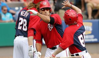 Ian Desmond (center), who already has established himself as one of the best shortstops in the game, is poised to build on his previous two seasons and have a true breakout year as a key element in the Nationals returning to the postseason in the first year of manager Matt Williams&#39; tenure in D.C. (gregg newton/special to the washington times)