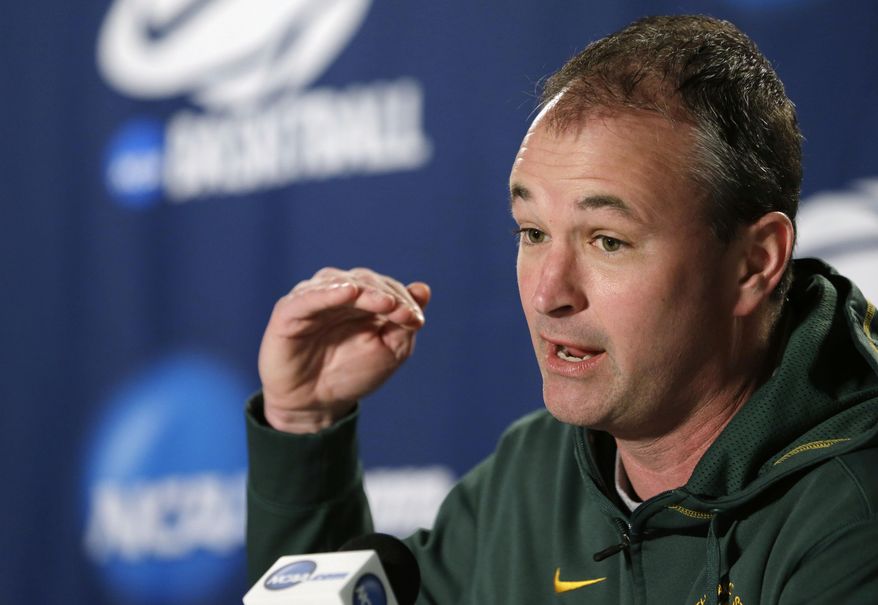 FILE - In this March 21, 2014 file photo, North Dakota State head coach Saul Phillips speaks at a news conference before the third round of the NCAA men's college basketball tournament in Spokane, Wash. Phillips is among 15 finalists for the 2014 Hugh Durham Award. The winner will be announced at the CollegeInsider.com Awards Banquet on April 4 in Dallas, site of this year’s Final Four. (AP Photo/Elaine Thompson, File)