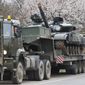 Ukrainian tanks are transported from their base in Perevalnoe, outside Simferopol, Crimea, Wednesday, March 26, 2014. Ukraine has started withdrawing its troops and weapons from Crimea, now controlled by Russia. (AP Photo/Pavel Golovkin)