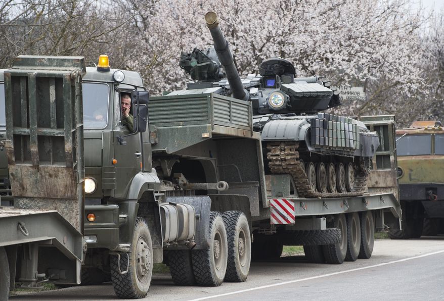 Ukrainian tanks are transported from their base in Perevalnoe, outside Simferopol, Crimea, Wednesday, March 26, 2014. Ukraine has started withdrawing its troops and weapons from Crimea, now controlled by Russia. (AP Photo/Pavel Golovkin)