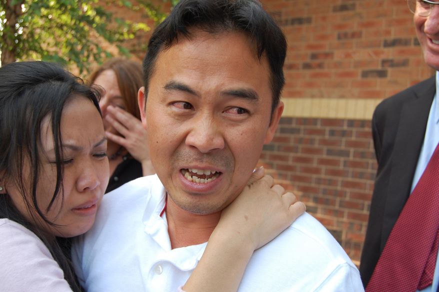In this Aug. 5, 2010 photo, Koua Fong Lee embraces his wife, Panghoua Moua, outside of the Ramsey County jail, moments after learning that Ramsey County Attorney Susan Gaertner would not seek a new case against Lee in St. Paul, Minn. Lawmakers are considering a bill that would compensate people who are wrongfully imprisoned in Minnesota, giving them at least $50,000 a year for every year they spent behind bars. Such a bill could help people like Koua Fong Lee, whose conviction in a crash involving a Toyota was overturned when it was revealed that the car had a problem with sudden acceleration. Lee was exonerated in 2010 after three years in prison. (AP Photo/Minnesota Public Radio, Tom Weber )