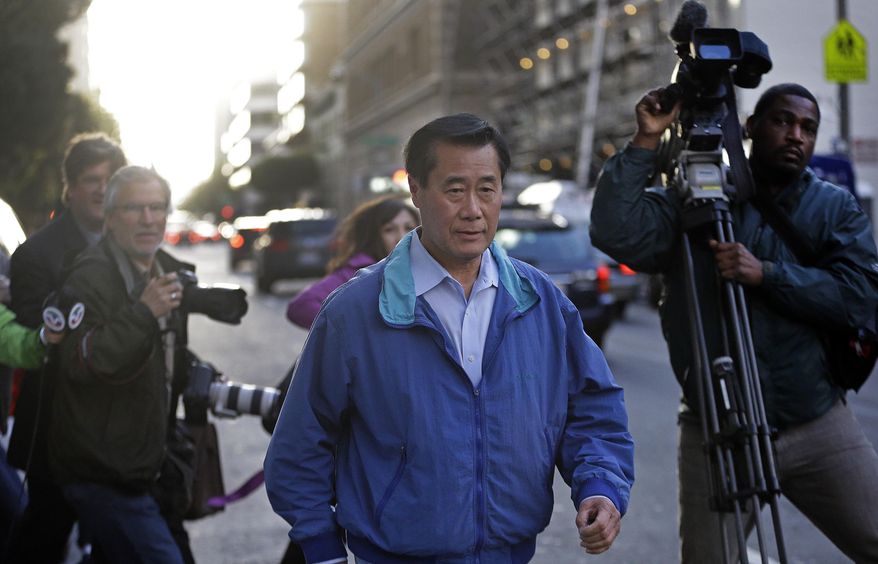 California Sen. Leland Yee, D-San Francisco, right, leaves the San Francisco Federal Building, Wednesday, March 26, 2014, in San Francisco. The FBI has filed a 137-page affidavit outlining a detailed corruption case against Yee, who is accused of asking for campaign donations in exchange for introducing an undercover agent to an arms trafficker. (AP Photo/Ben Margot)