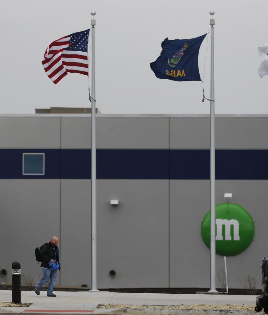 A man walks out the entrance of the new Mars Inc. production facility near Topeka, Kan., Wednesday, March 26, 2014. It&#39;s the company&#39;s first new North American production facility in 35 years. (AP Photo/Orlin Wagner)