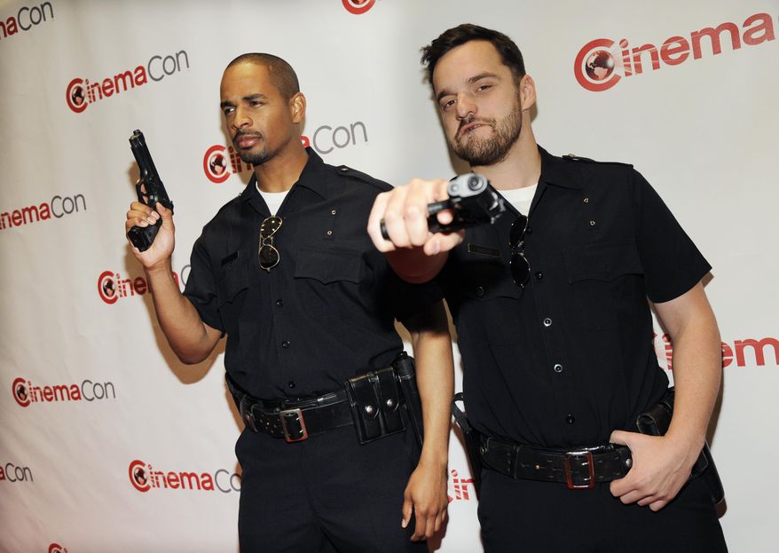 Jake Johnson, right, and Damon Wayans Jr., cast members in the upcoming film "Let's Be Cops," pose together before the 20th Century Fox presentation at CinemaCon 2014 on Thursday, March 27, 2014, in Las Vegas. (Photo by Chris Pizzello/Invision/AP)