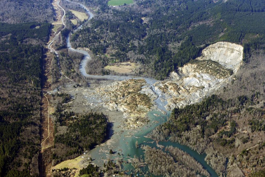AP10ThingsToSee - This aerial photo taken Monday, March 24, 2014 shows the massive mudslide that killed at least eight people Saturday and left dozens missing, near Arlington, Wash. (AP Photo/Ted S. Warren, File)