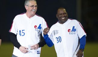 Former Montreal Expos Steve Rogers, left,  and Tim Raines share a laugh during a ceremony prior to a pre-season game between the Toronto Blue Jays and the New York Mets Friday, March 28, 2014 in Montreal.  (AP Photo/The Canadian Press, Paul Chiasson) ** FILE **