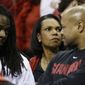 Former U.S. Secretary of State Condoleezza Rice, center watches play between Dayton and Stanford during the first half in a regional semifinal game at the NCAA college basketball tournament, Thursday, March 27, 2014, in Memphis, Tenn. (AP Photo/Mark Humphrey)
