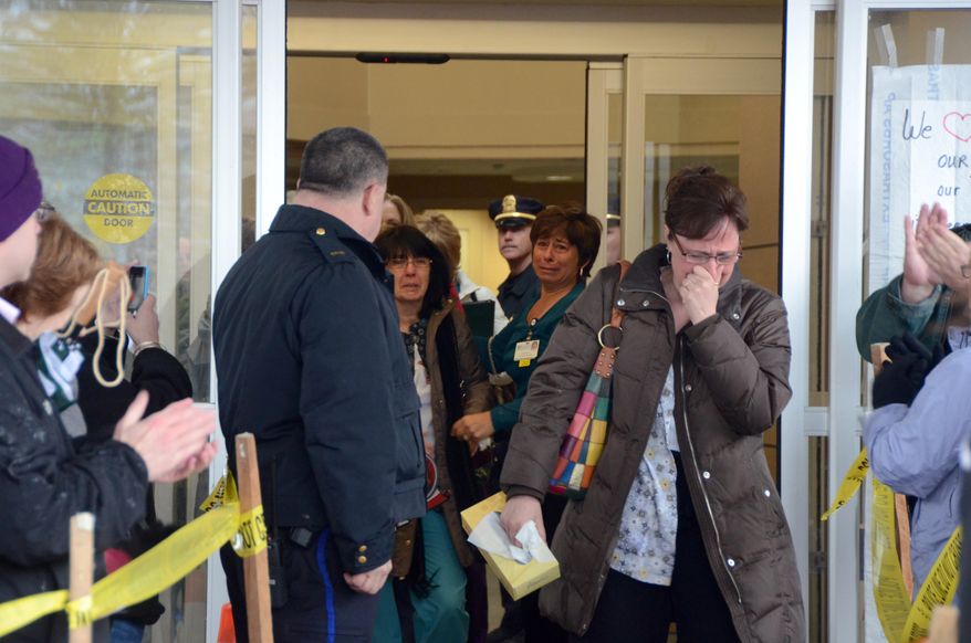 Jennifer Dowling can hardly hold back tears as she and other nurses leave their final shifts at North Adams Regional Hospital on Friday, March 28, 2014, in North Adams, Mass. The hospital announced the closure of the community hospital on Tuesday. (AP Photo/The Berkshire Eagle, Gillian Jones)