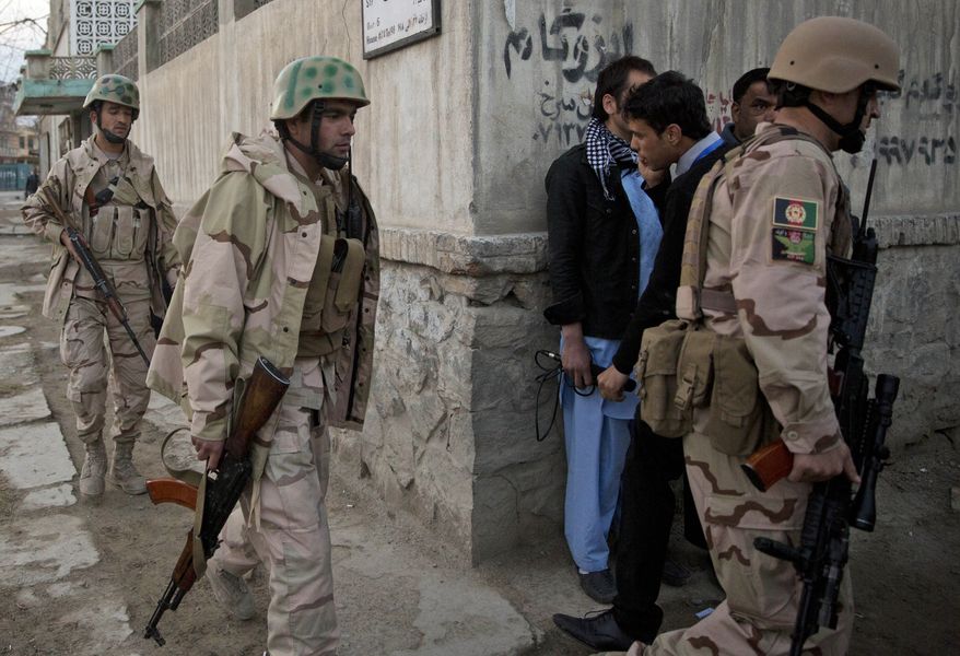 Afghan special forces move in after four suicide bombers armed with assault rifles and hand grenades attacked an “office of foreigners” in a southwestern neighborhood of Kabul, Afghanistan, Friday, March 28, 2014. A Taliban spokesman said insurgents attacked a “guest house of foreigners and a church of foreigners.” His claim could not be immediately confirmed. (AP Photo/Anja Niedringhaus)