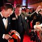FILE - Denver Broncos quarterback Peyton Manning, left, signs autographs while walking the red carpet to the Ovation Theater, in this March 14 2014 file photo taken at the Maxwell Football Awards at the Revel Casino and Hotel in Atlantic City, N.J. (AP Photo/The Press of Atlantic City, Ben Fogletto) MANDATORY CREDIT