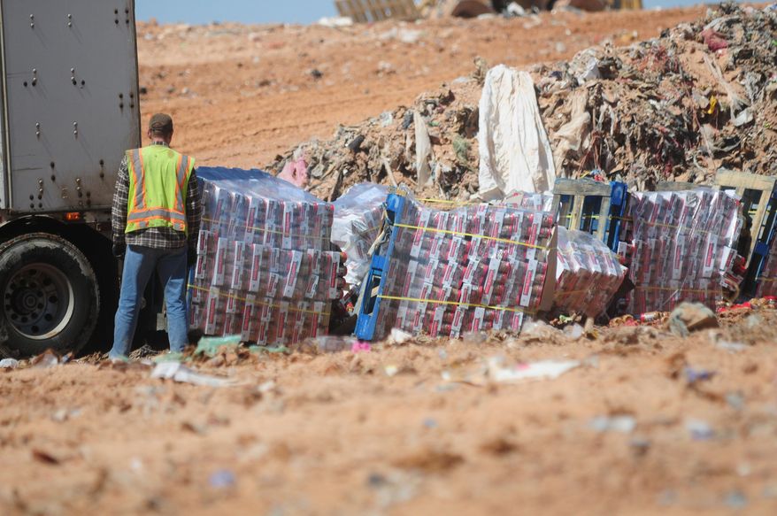 Peanut butter is disposed of Friday March 28, 2014 at the dump in Clovis, N.M. Nearly a million jars of peanut butter are being dumped at a New Mexico landfill to expedite the sale of a bankrupt peanut-processing plant that was at the heart of a 2012 salmonella outbreak and nationwide recall.(AP Photo/Clovis News-Journal, Tony Bullocks)