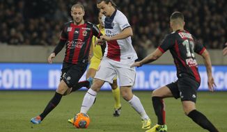 Paris Saint Germain&#39;s Zlatan Ibrahimovic of Sweden, center, controls the ball past Nice&#39;s Mathieu Bodmer of France, left, during their French League One soccer match, in Nice stadium,southeastern France, Friday, March 28, 2014. (AP Photo/Lionel Cironneau)