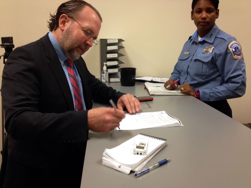 Businessman Mark Witaschek enrolls in D.C. Gun Offenders Registry at the Metropolitan Police Department. March 28, 2013.