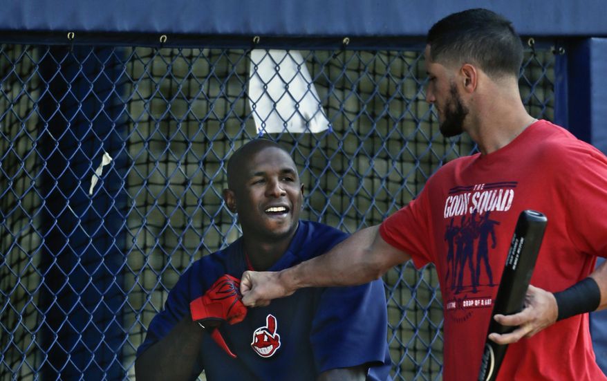 Cleveland Indians catcher Yan Gomes,  right, knocks knuckles with right fielder Nyjer Morgan before a spring exhibition baseball game on Friday, March 28, 2014, in San Diego. (AP Photo/Lenny Ignelzi)