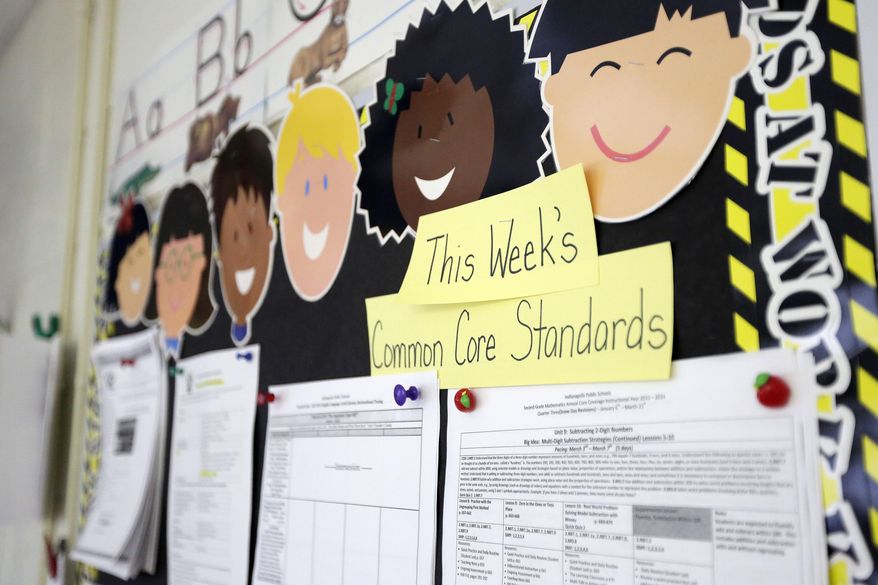 In this photo taken on Tuesday, March 25, 2013, Common Core standards are posted on a bulletin board in a second grade classroom at George Buck Elementary School in Indianapolis. The national math and education standards outlined in the Common Core are everywhere at Buck Elementary. Stapled packets of the standards hang outside classroom doors, and individual guidelines are cut out and displayed in the hallways next to hand-drawn graphs scribbled in crayon. A bill signed last Monday by Gov. Mike Pence makes Indiana the first state to revoke those standards, but what will replace them is unclear in a state where teachers are still reeling from years of change. (AP Photo/AJ Mast)