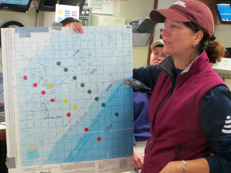 In this March 20, 2014 photo, Leslie Sautter, an associate professor in the department of geology and environmental geosciences at the College of Charleston shows a map of the waters off South Carolina aboard the Research Vessel Savannah in Charleston Harbor in Charleston, S.C. Students aboard the vessel completed several days of mapping the mid-intercontinental shelf off South Carolina. (AP Photo/Bruce Smith)