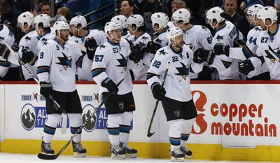 San Jose Sharks defenseman Dan Boyle, front right, is congratulated after scoring a goal as teammates Marty Havlat, of the Czech Republic, front left, and Tommy Wingels follow past the team box while facing the Colorado Avalanche in the second period of an NHL hockey game in Denver on Saturday, March 29, 2014. (AP Photo/David Zalubowski)