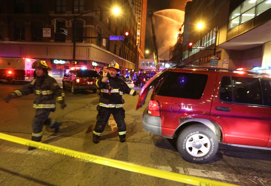 Fire crews from Des Moines work to control a fire at the Younkers building in downtown Des Moines, Iowa early Saturday, March 29, 2014. The massive fire swept through a century-old building that was being renovated, causing its upper floors to collapse and authorities to close down numerous streets in downtown Des Moines. No one was injured. Des Moines Fire Department spokesman Brian O'Keefe said it first got word of a fire at the former Younkers department store building at about 12:50 a.m. Saturday, and arrived to find flames leaping from the upper floors of the seven-floor building, which dates to 1899. (AP Photo/The Des Moines Register, Bryon Houlgrave) MANDATORY CREDIT THE DES MOINES REGISTER BRYON HOULGRAVE