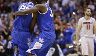 Kentucky&#39;s Alex Poythress (22) and Julius Randle (30) celebrate after an NCAA Midwest Regional semifinal college basketball tournament game against the Louisville Saturday, March 29, 2014, in Indianapolis. Kentucky won 74-69. (AP Photo/Michael Conroy)