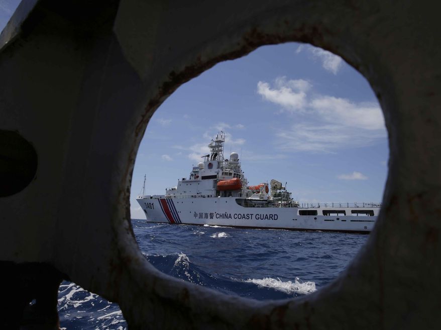 A China Coast Guard vessel attempts to block a Philippine government vessel as the latter tries to enter the China Second Thomas Disputed Shoals (local name Ayungin Shoal) to replace Philippine troops and resupply provisions Saturday, March 29, 2014 off the South China Sea. Chinese coast guard ships set up a blockade but a lone Philippine boat maneuvered past them in the high seas Saturday to deliver a fresh batch of Filipino troops and food supplies to a disputed shoal in a tense, cat-and-mouse-like confrontation witnessed for the first time by journalists in the South China Sea. (AP Photo/Bullit Marquez)