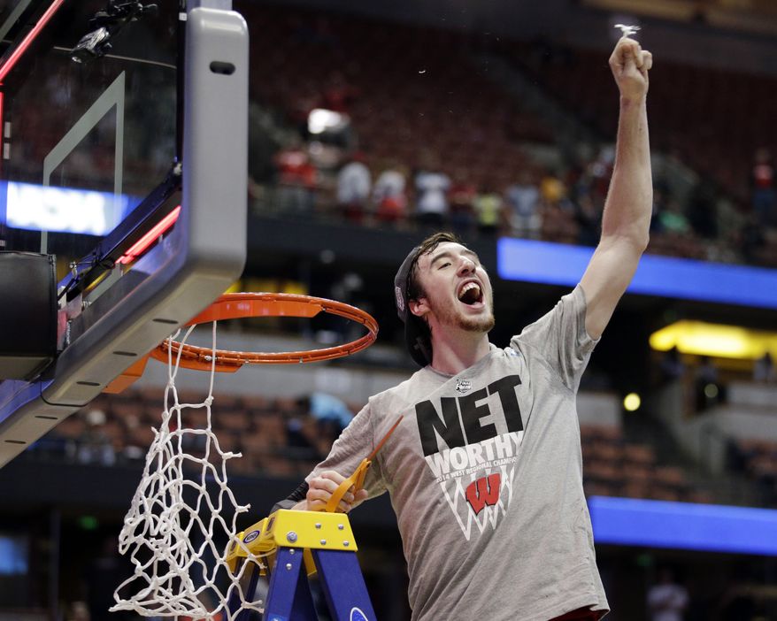 Wisconsin 's Frank Kaminsky cuts down the net after a regional final NCAA college basketball tournament game against Arizona, Saturday, March 29, 2014, in Anaheim, Calif. Wisconsin won 64-63 in overtime. (AP Photo/Jae C. Hong)