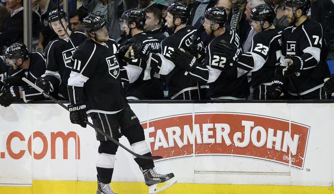 Los Angeles Kings center Anze Kopitar celebrates after scoring a goal against Winnipeg Jets during the first period of an NHL hockey game Saturday, March 29, 2014, in Los Angeles. (AP Photo/Kevork Djansezian)