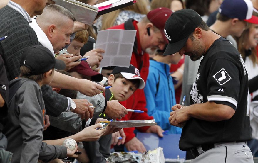 Paul Konerko signs autographs for fans before a spring exhibition baseball game against the Birmingham Barons on Friday, March 28, 2014, in Birmingham, Ala. (AP Photo/Butch Dill)