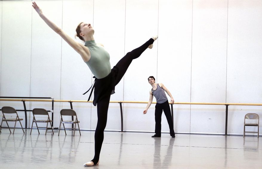ADVANCE FOR USE MONDAY, MARCH 31 - In this photo taken on Feb. 26, 2014, choreographer Gavin Stewart, right, watches Richmond Ballet dancer Lauren Fagone as he refines the dance he choreographed for the New Works Festival in March in Richmond, Va. (AP Photo/Richmond Times-Dispatch, Alexa Welch Edlund)
