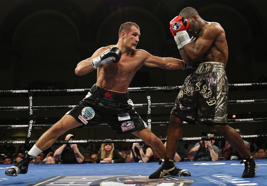 Sergey Kovalev, left, of Russia, punches Cedric Agnew, of the United States, during the sixth round of WBO light heavyweight boxing title in Atlantic City, N.J., on Saturday, March 29, 2014. Kovalev won by knockout in the seventh round. (AP Photo/Tim Larsen)