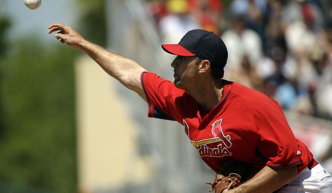 St. Louis Cardinals starting pitcher Adam Wainwright throws in the second inning of an exhibition spring training baseball game against the Washington Nationals, Wednesday, March 26, 2014, in Jupiter, Fla. (AP Photo/David Goldman)