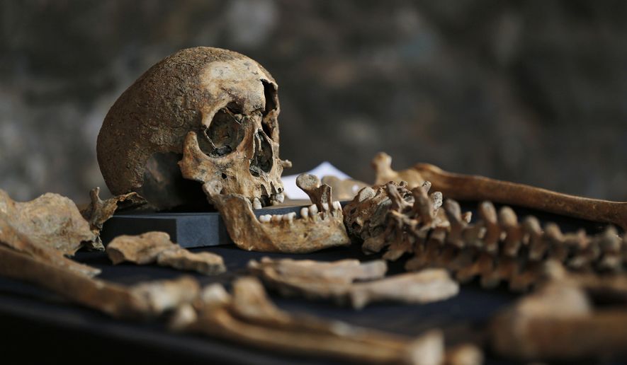 In this Wednesday, March 26, 2014, file photo, one of the skeletons found by construction workers under central London&#39;s Charterhouse Square is pictured. Twenty-five skeletons were uncovered last year during work on Crossrail, a new rail line that&#39;s boring 13 miles (21 kilometers) of tunnels under the heart of the city. Archaeologists immediately suspected the bones came from a cemetery for victims of the bubonic plague that ravaged Europe in the 14th century. The Black Death, as the plague was called, is thought to have killed at least 75 million people, including more than half of Britain&#39;s population. (AP Photo/Lefteris Pitarakis)