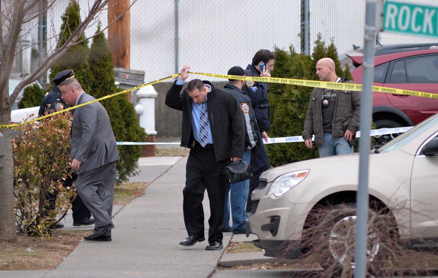 FILE - In this March 28, 2014 file photo, a detective passes under crime scene tape as New York City Police investigate the scene of a double shooting in the Rosebank section of the Staten Island borough of New York. Police say that Heriberto Pagan shot his grandson, Michael Feliciano, in the head before killing the Feliciano's girlfriend, Claritle Huerta. Police say Pagan then got in his car, drove a few blocks and turned the gun on himself. Feliciano told the Daily News from his hospital bed that Huerta called him on his way home Friday evening to tell him that his grandfather was there and wanted to talk to him. (AP Photo/Staten Island Advance, Bill Lyons, File) NO SALES
